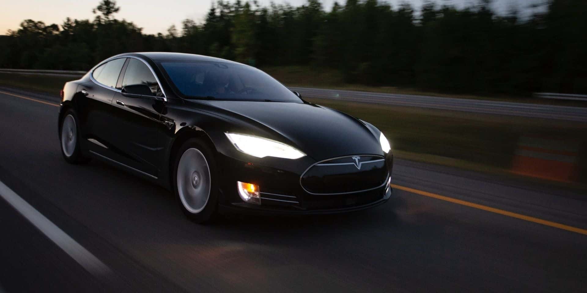 Picture of a Tesla model s driving on a road